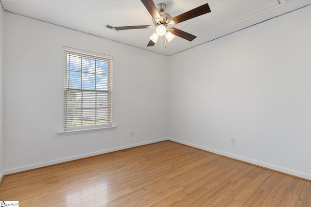 spare room featuring ceiling fan and light hardwood / wood-style floors