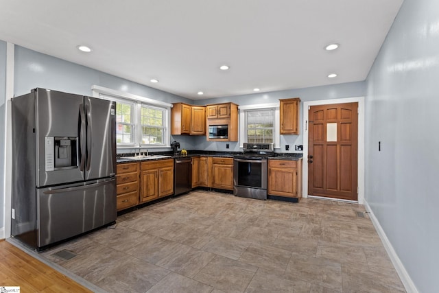 kitchen featuring stainless steel appliances, a healthy amount of sunlight, and sink