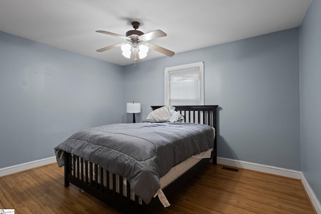 bedroom with ceiling fan and dark hardwood / wood-style floors