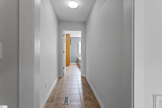 corridor featuring dark tile patterned flooring