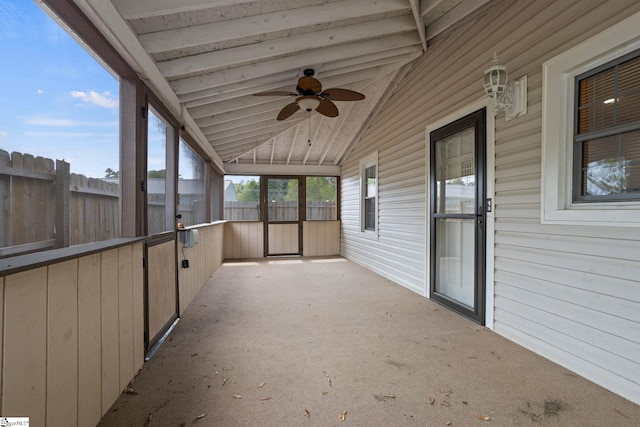 unfurnished sunroom with vaulted ceiling and ceiling fan