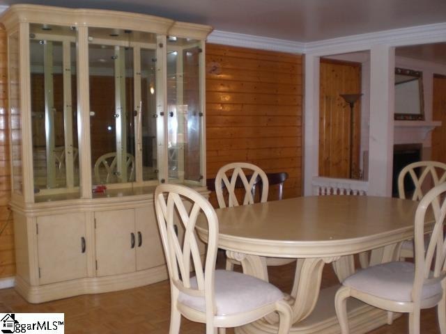 dining room with wood walls