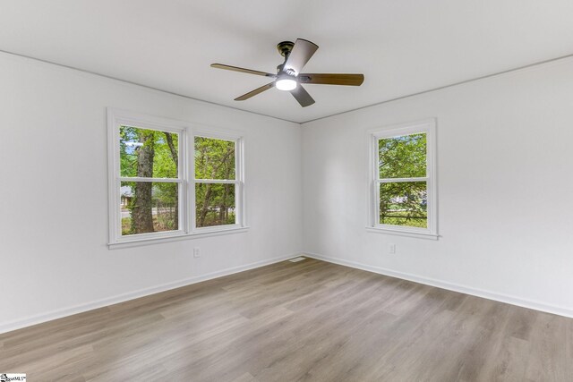 unfurnished room with light hardwood / wood-style flooring and ceiling fan