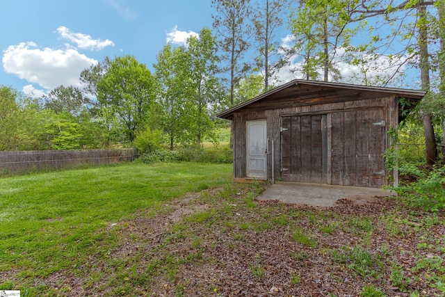 view of outbuilding featuring a yard