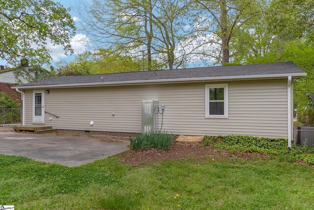 back of house with a yard, a patio area, and central AC