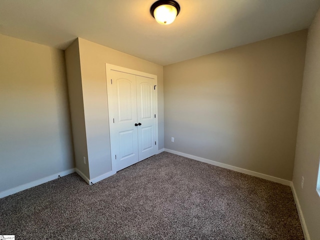 unfurnished bedroom featuring carpet flooring and a closet