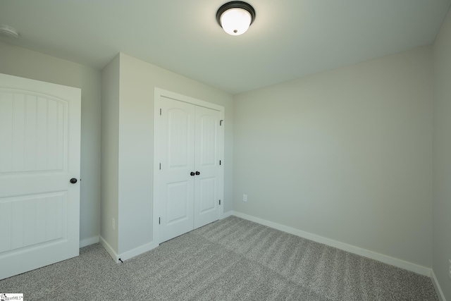 unfurnished bedroom with a closet and carpet