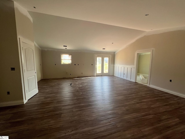 unfurnished room featuring french doors, dark hardwood / wood-style floors, and vaulted ceiling