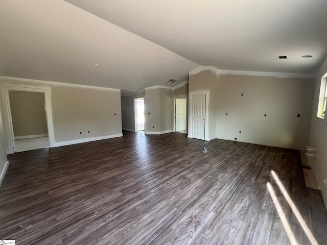 unfurnished living room featuring dark hardwood / wood-style flooring and lofted ceiling