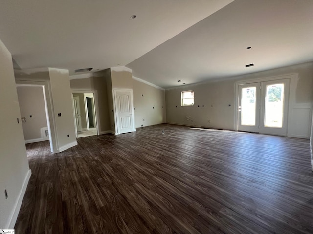 unfurnished living room featuring dark hardwood / wood-style floors, lofted ceiling, and ornamental molding