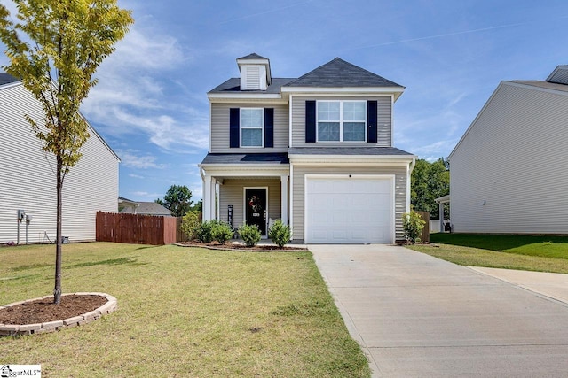 view of property featuring a garage and a front yard