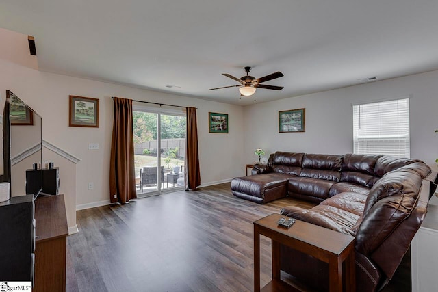 living room with ceiling fan and dark hardwood / wood-style flooring