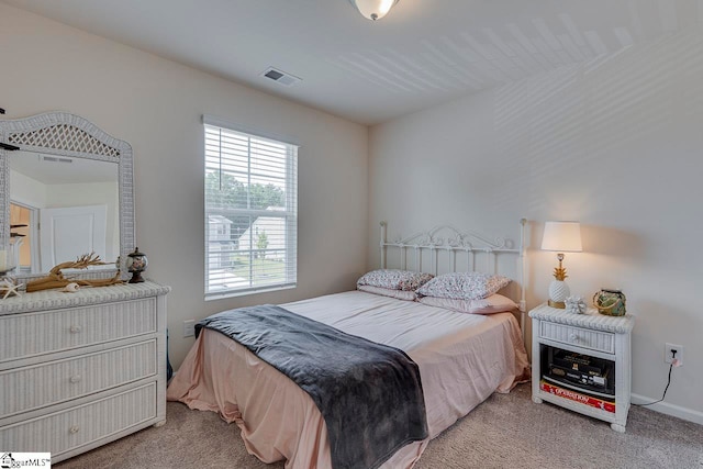 bedroom featuring light carpet