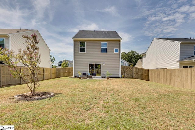 rear view of property featuring a lawn and a patio