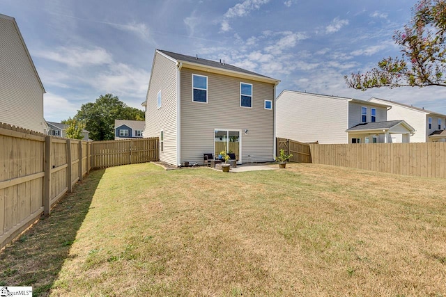 back of property with a yard and a patio