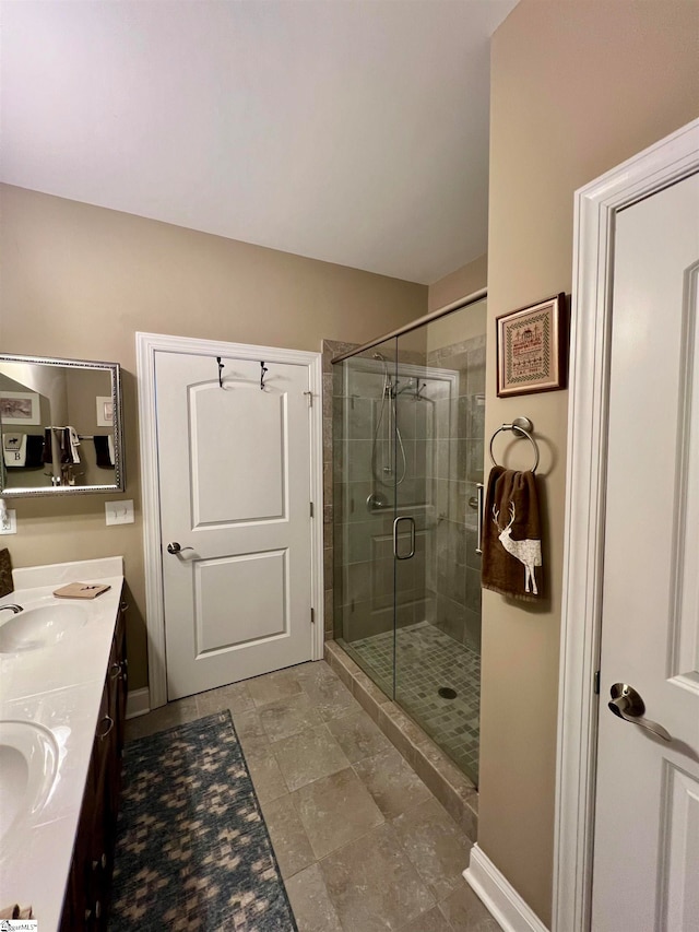 bathroom featuring vanity and a shower with shower door