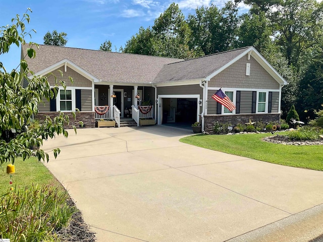 view of front facade featuring a front lawn, a porch, and a garage