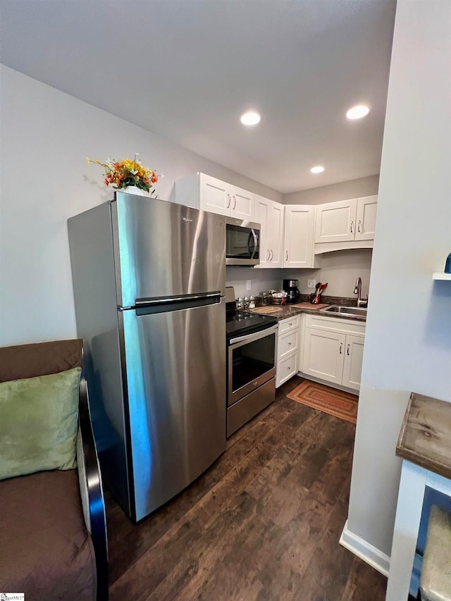 kitchen featuring white cabinets, sink, stainless steel appliances, and dark wood-type flooring