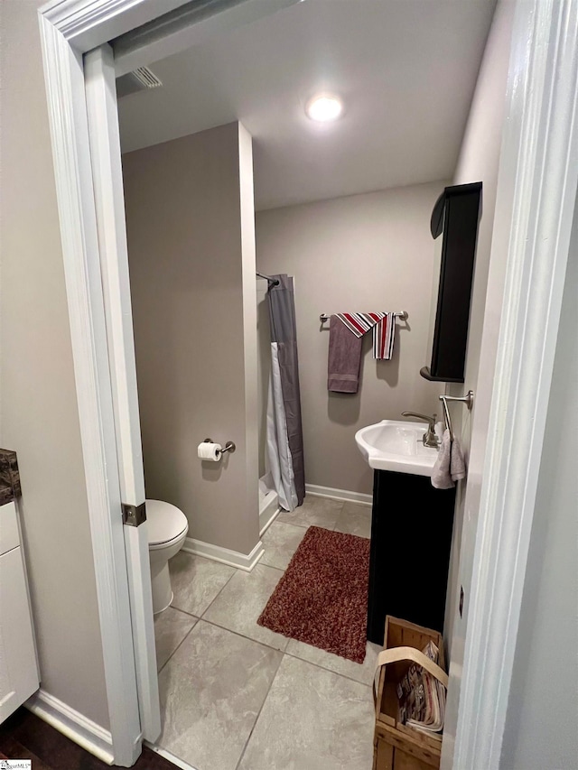 bathroom featuring tile patterned flooring, vanity, a shower with shower curtain, and toilet