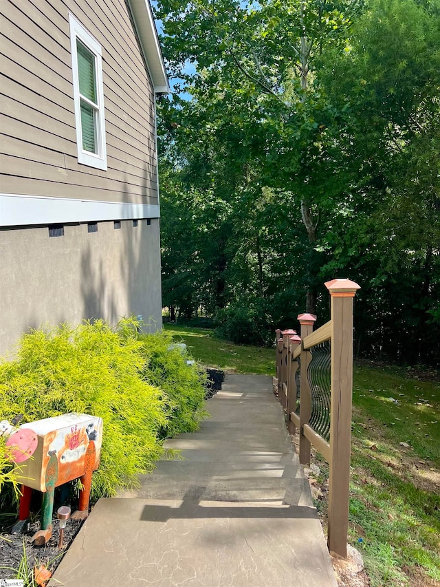 view of side of home featuring a lawn