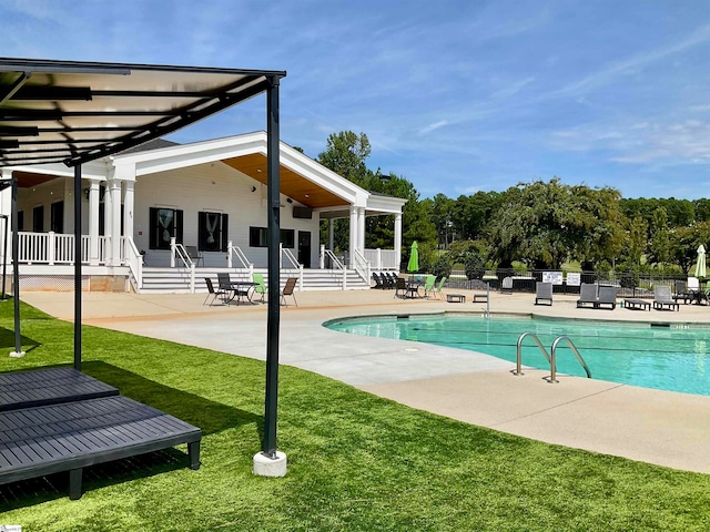 view of pool featuring a patio and a lawn