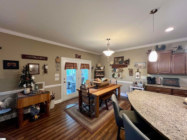 dining room with french doors, dark hardwood / wood-style flooring, and crown molding