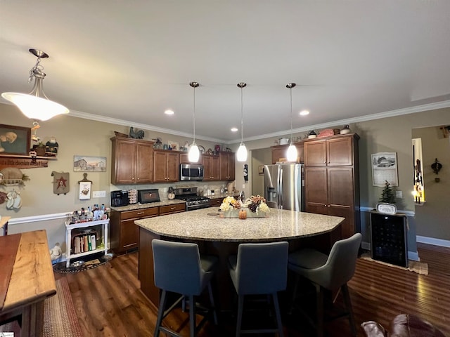 kitchen featuring a kitchen island, dark hardwood / wood-style floors, decorative light fixtures, and appliances with stainless steel finishes