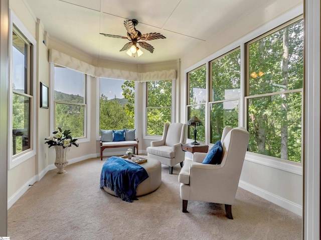 sunroom featuring ceiling fan