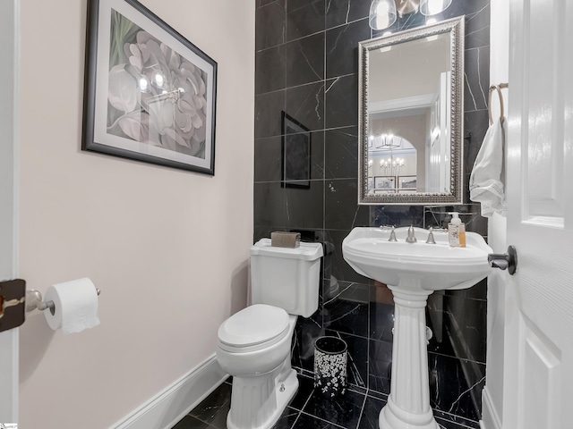 bathroom with tile walls, toilet, and tile patterned floors