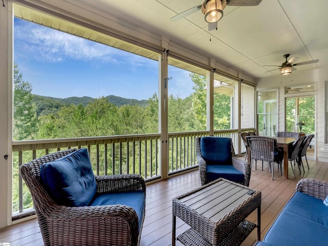 sunroom featuring ceiling fan and a wealth of natural light