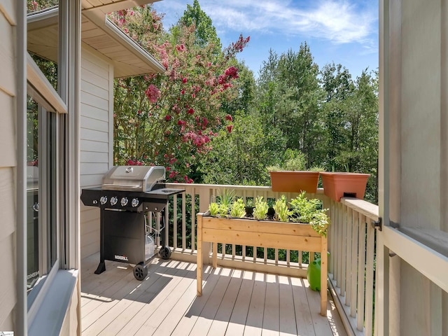 wooden terrace with a grill