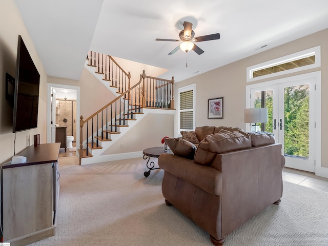 living room featuring ceiling fan, carpet, and french doors