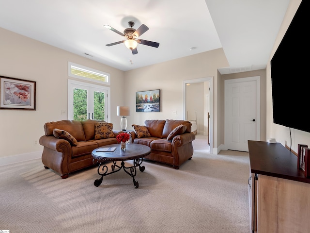 carpeted living room featuring ceiling fan