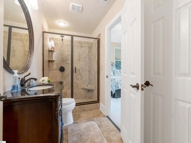 bathroom with an enclosed shower, tile patterned flooring, toilet, and vanity