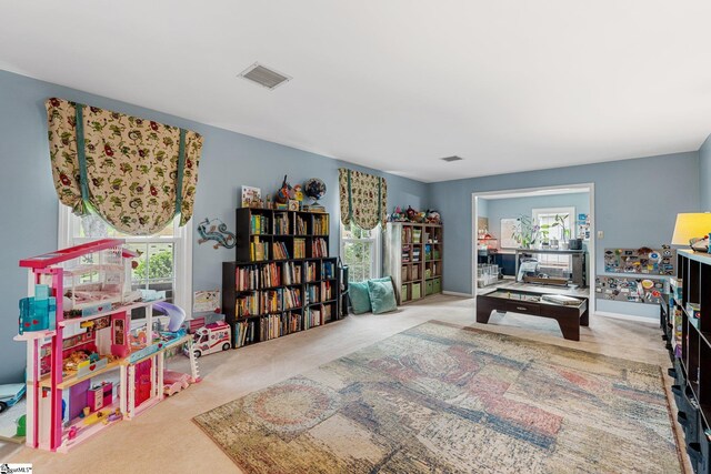 game room featuring light carpet