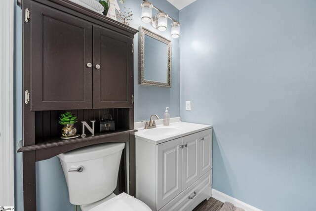 bathroom featuring vanity and toilet