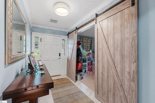 entrance foyer with a barn door and ornamental molding