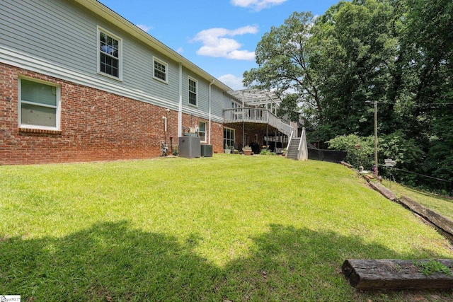 view of yard featuring cooling unit and a wooden deck