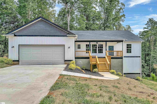 view of front of house featuring a front lawn, a garage, and covered porch