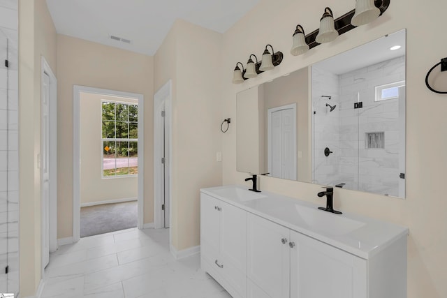 bathroom with tiled shower and vanity