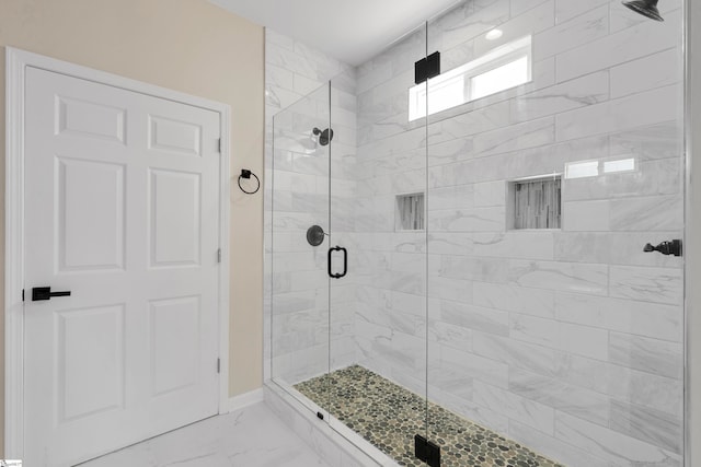 bathroom with a shower with door