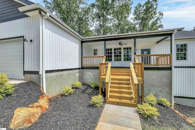 view of front facade with a garage, covered porch, and ceiling fan