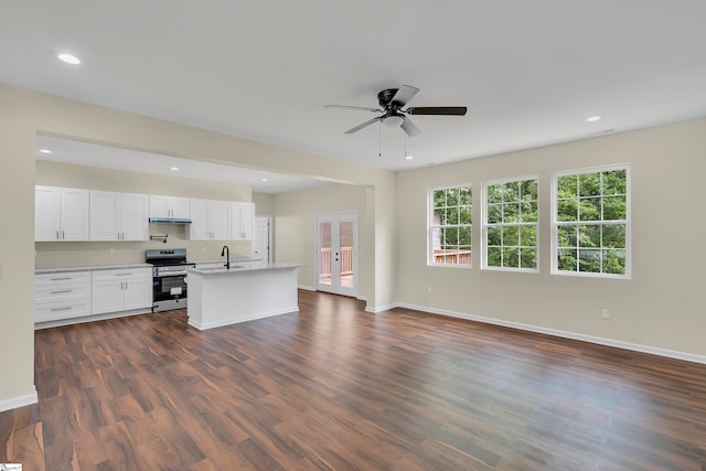 kitchen with stainless steel range oven, dark hardwood / wood-style flooring, ceiling fan, light stone countertops, and white cabinets