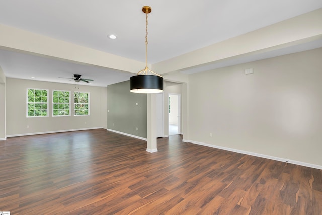 unfurnished living room featuring ceiling fan and dark hardwood / wood-style floors