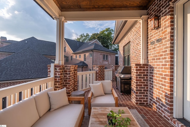 balcony with an outdoor living space and area for grilling