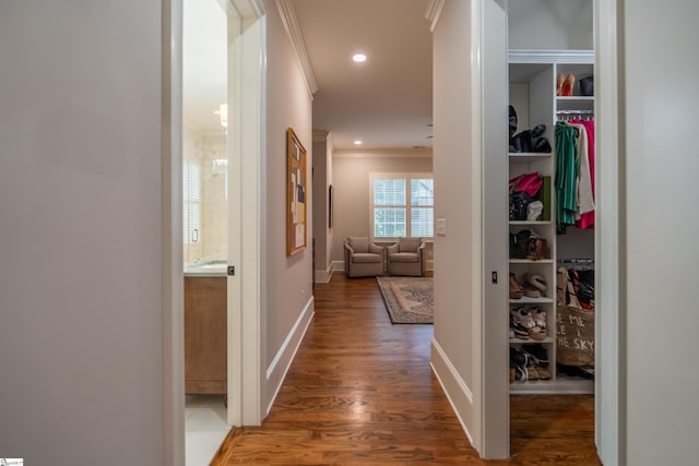 hallway with recessed lighting, crown molding, baseboards, and wood finished floors