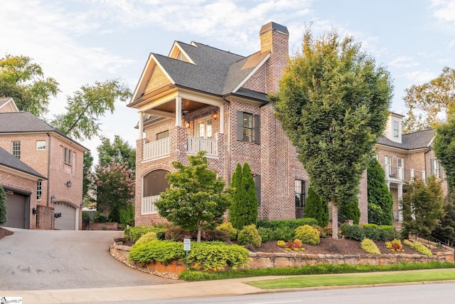 view of front of home featuring a balcony and a garage