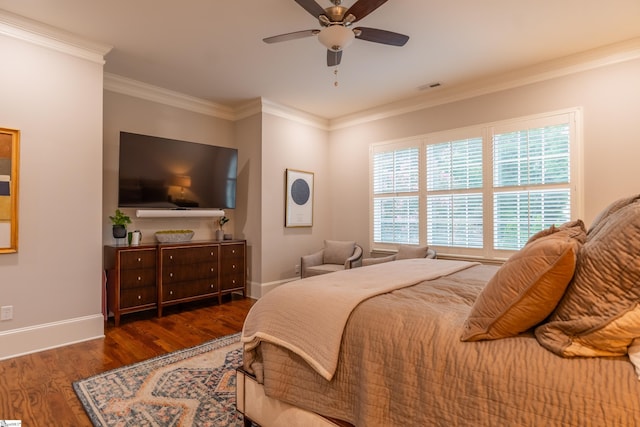 bedroom with ornamental molding, visible vents, baseboards, and wood finished floors