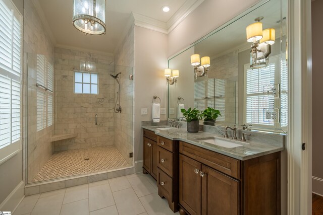 bathroom featuring double vanity, a shower stall, ornamental molding, and a sink