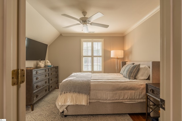 bedroom featuring lofted ceiling, ceiling fan, hardwood / wood-style flooring, and crown molding